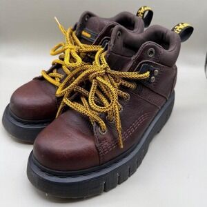 Brown leather Dr. Martens boots with yellow laces boots
